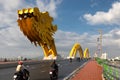 Danang / Vietnam - 01/05/2020: Dragon bridge CÃ¡ÂºÂ§u RÃ¡Â»âng and motos crossing in Da Nang city